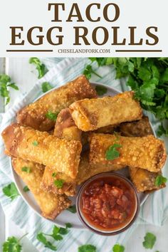 egg rolls on a plate with salsa and ketchup in the middle, surrounded by cilantro leaves