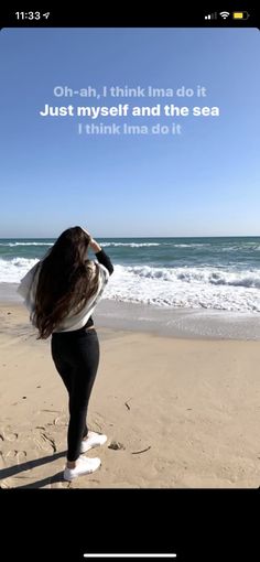 a woman standing on top of a sandy beach next to the ocean with a quote above her