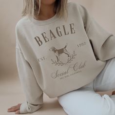 Experience sophistication and companionship in our premium Beagle Social Club Sweatshirt. Designed for those with a taste for luxury, this sweatshirt seamlessly combines comfort with elegance. Embrace both coziness and fashion as you proudly display your love for Beagles. Customize it and make it a perfect gift for your friends and family.  Note: The font colors will match the pictured shirt colors. (See images for matching font colors) .: 50% cotton, 50% polyester  .: Medium-heavy fabric (8.0 o Beagle Hound, Match Font, Poodle Mom, Mom Crewneck, Mama Sweater, French Poodles, Vintage Poodle, Club Sweatshirts, Poodle Dog