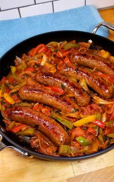 sausages and peppers are cooking in a skillet