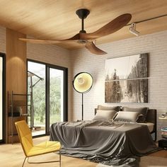 a bedroom with a bed, ceiling fan and large windows