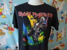 an iron maiden t - shirt hanging on a mannequin