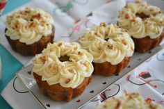 small cupcakes with white frosting on a plate