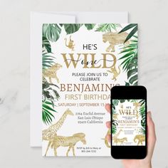 a person holding up a phone in front of an animal themed birthday party card with the text he's wild, please join us to celebrate