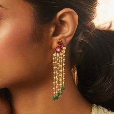 Description : Introducing our regal gold-plated silver Earring, adorned with an enchanting peacock motif crafted in the intricate Jadau technique. The ethereal design is complemented by delicate pearl strands gracefully hanging underneath, adding a touch of timeless elegance. Embrace the essence of royalty and tradition as you don these earrings, perfectly designed to elevate your ethnic look with grace and sophistication. Product Information : Metal: 925 Silver with 1.0 microns Gold Plating Len Festive Elegant Dangling Bead Earrings, Festive Elegant Earrings With Dangling Beads, Elegant Kundan Chandelier Earrings With Dangling Beads, Elegant Kundan Danglers With Dangling Beads, Elegant Kundan Danglers With Beads, Elegant Kundan Bridal Earrings With Dangling Beads, Fusion Style Pearl Drop Chandelier Earrings For Celebration, Fusion Style Chandelier Earrings With Pearl Drop For Celebration, Elegant Danglers With Dangling Beads For Celebration