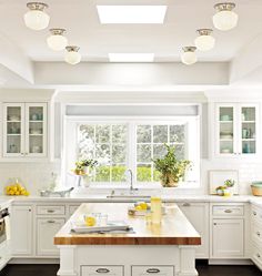 an image of a kitchen with white cabinets and counter tops, as well as pictures on the phone