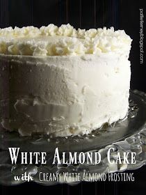 a close up of a cake on a plate with the words, white almond cake