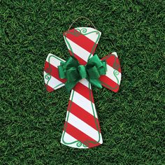 an ornament on the grass with a green bow