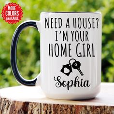 a black and white coffee mug that says need a house? i'm your home girl