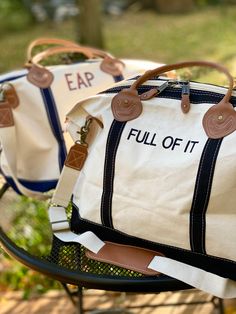 "This Weekender bag is perfect for a quick overnight trip or weekend getaway. The classic style boat tote in a variety of strap accent colors can be monogrammed or embroidered with your choice of phrases. Up to 10 characters per line, up to 3 lines of space. Choose a name, team, or my personal favorite- go with a funny phrase. So many font choices and monograms available, reach out if you don't see quite what you're after or need inspiration! 15\" H X 28\" W X 10\" D 3.45 lbs 18 oz Canvas Top zip closure with leather accent pullers Genuine leather handles Internal pocket with zipper closure Brass clips for removable shoulder strap Weekenders have a zipper closure & exterior pocket, as well as interior pockets that zip. They are sturdy and durable canvas that is made to last. with genuine l Overnight Bag For Boyfriends House, Casual Travel Shoulder Bag With Embroidered Logo, Casual Shoulder Bag With Embroidered Logo For Travel, Casual Tote Travel Bag For Overnight Trips, Travel Shoulder Bag With Embroidered Logo, Canvas Travel Bag For Overnight Trips, Casual Weekender Shoulder Bag For Overnight Trips, Casual Weekender Bag For Overnight Trips, Casual Shoulder Weekender Bag For Overnight Trips