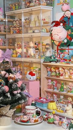 a room filled with lots of different types of toys and decorations on shelves next to a christmas tree