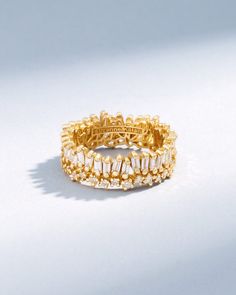 Crafted with 18-karat gold, this ring is a modern twist to the classic eternity band. It features a row of vertically set diamond baguettes placed on top of a row of unevenly set round white diamonds. A perfect statement and everyday piece. Details 18k yellow gold, rose gold or white gold 2.37 carats of baguette and round white diamonds 8mm width Ref: BAR741 Gold Baguette Cut Stackable Eternity Band, Luxury 14k Gold Baguette Cut Eternity Band, 14k Yellow Gold Multi-stone Eternity Band, Luxury Yellow Gold Multi-stone Eternity Band, Yellow Gold Multi-stone Eternity Band In Cubic Zirconia, Rainbow Sapphires, Diamond Stacks, Ruby Sapphire, Tennis Necklace