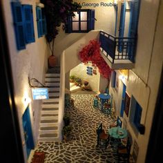 an overhead view of a house with stairs leading up to the second floor and blue shutters