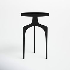 a small black table sitting on top of a white floor