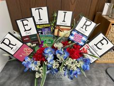 a vase filled with flowers and cards that spell out the word e t p r