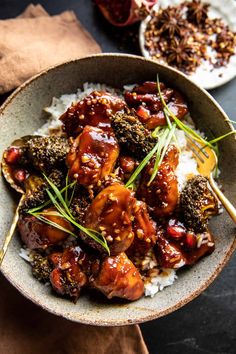 a bowl filled with meat and rice on top of a table