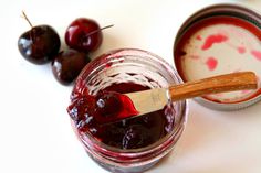 cherries and yogurt sit on a white surface