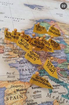 a map with pins pinned to it and the names of countries marked in yellow tape