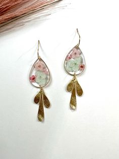 Real pressed pastel peach forget me nots and mint hydrangeas preserved in shiny resin with a gold plated brass leaf charms dangling below. Hooks are brass. Ultra feminine, chic and super lightweight. Perfect for all day wear! Dainty Spring Flower Earrings For Wedding, Dainty Flower Earrings For Spring Wedding, Dainty Spring Wedding Flower Earrings, Dainty Pressed Flower Earrings For Wedding, Elegant Resin Earrings With Pressed Flowers, Pink Resin Jewelry With Pressed Flowers, Silver Pressed Flower Resin Earrings, Forget Me Not Resin Jewelry, Flower-shaped Resin Earrings With Pressed Flowers