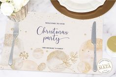 a christmas party place setting with silverware and napkins on a marble table top