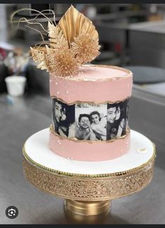 a pink and gold cake with photos on it