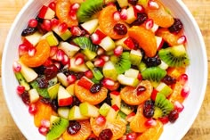 a white bowl filled with sliced fruit on top of a table