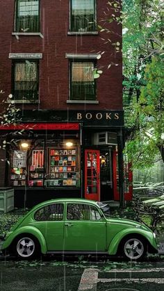 a green car parked in front of a bookshop on a rainy day with trees