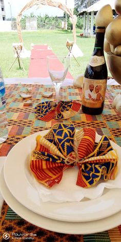 a plate with some food on it and a bottle of wine in the back ground