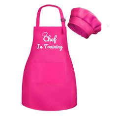 a pink chef's apron with the words chef in training on it and a hat