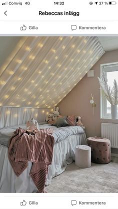 an attic bedroom with string lights on the ceiling