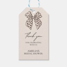 a tag with a bow on it that says thank you for celebrating with us