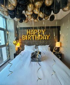 a bedroom decorated for a birthday with balloons and streamers