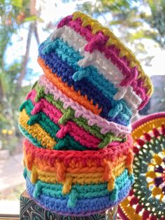 there are many crocheted baskets stacked on top of each other