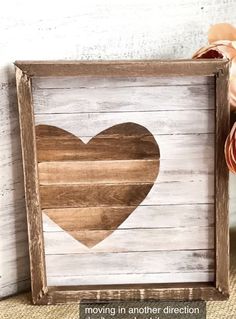 a wooden frame with a heart painted on it