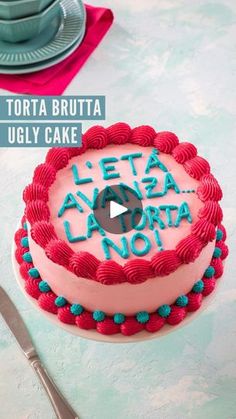 a cake with the words letta lavora not written on it, sitting next to a fork and knife