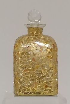 a yellow glass bottle on a clear base