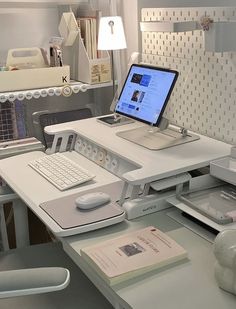 a laptop computer sitting on top of a white desk