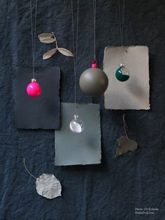 some ornaments hanging from strings on a wall