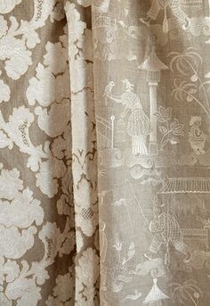 the curtain is closed and there are many different designs on this piece of fabric,