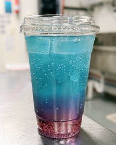 a plastic cup filled with liquid sitting on top of a counter