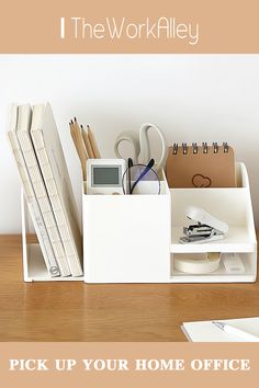 an office desk with various items on it and a calculator in the holder