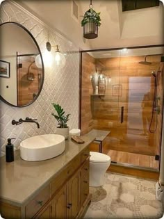 a bathroom with a sink, toilet and shower stall in it's own area