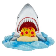 a toy shark with a piece of pizza in it's mouth on the water