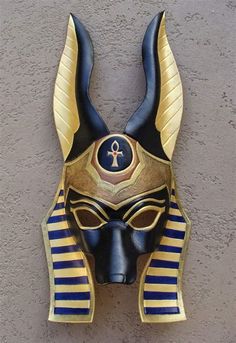 an egyptian mask hanging on the wall