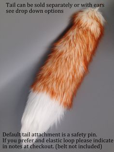 an orange and white cat's tail with the caption, tails can be sold separately or with ears see drop down options