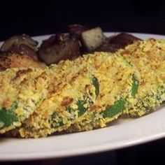 an omelet is on a white plate with mushrooms