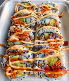 sushi rolls with sauce drizzled over them