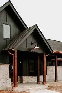 the front entrance to a building with wooden pillars