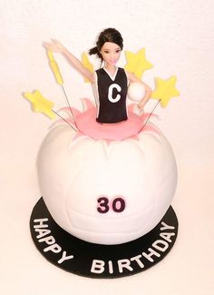 a birthday cake with a girl on top and stars around the base that says happy birthday