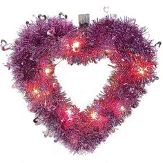 a purple heart shaped wreath with lights on the inside and in the shape of a heart